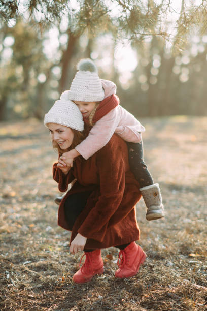 istock Mother and daughter have fun in the pine forest. 1204456499