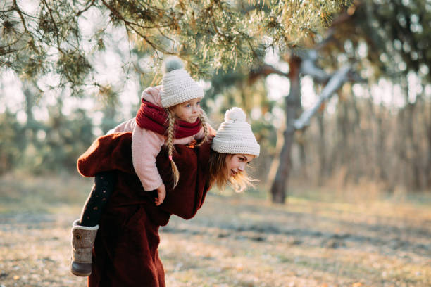istock Mother and daughter have fun in the pine forest. 1204456508