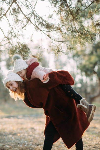 istock Mother and daughter have fun in the pine forest. 1204456510