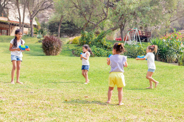 istock Little girls playing with water in the summer 1204456607