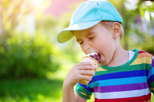 istock Happy child eating ice cream outdoors in summer 1204458638