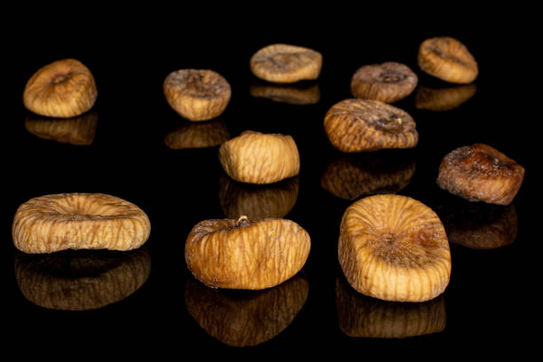 istock Dried fig fruit isolated on black glass 1204459417