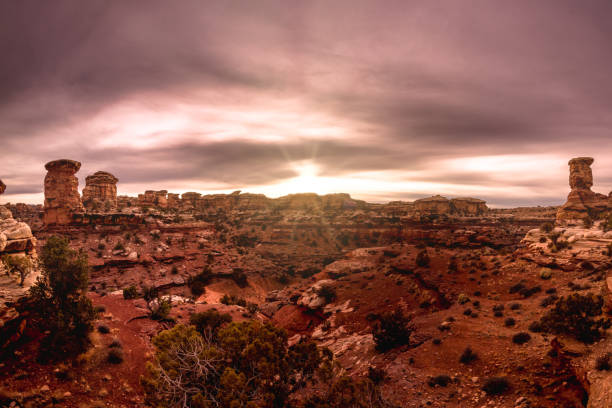 istock Dramatic cloudy sunset in Canyonlands National Park at the Needles district with sun rays 1204459430