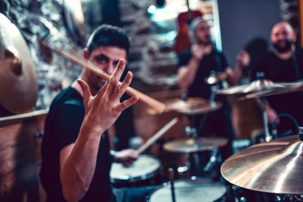 istock Drummer Spinning The Sticks While Rehearsing With Band 1204459459