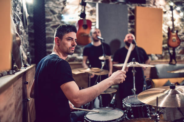 istock Drummer And His Backing Vocals Recording In Studio 1204459510