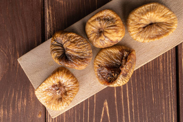 istock Dried fig fruit on brown wood 1204459524