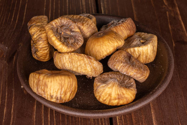 istock Dried fig fruit on brown wood 1204459662