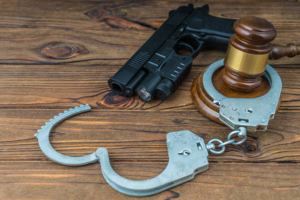 istock Judge hammer, gun and handcuffs. 1204460517