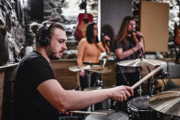 istock Drummer Leading His Band Into A Successful Recording Session 1204460971