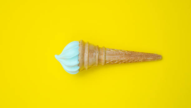 istock Ice cream cone, summer concept. Ice cream on colored background. Waffle cone with dessert. Side view. Minimal concept 1204461140