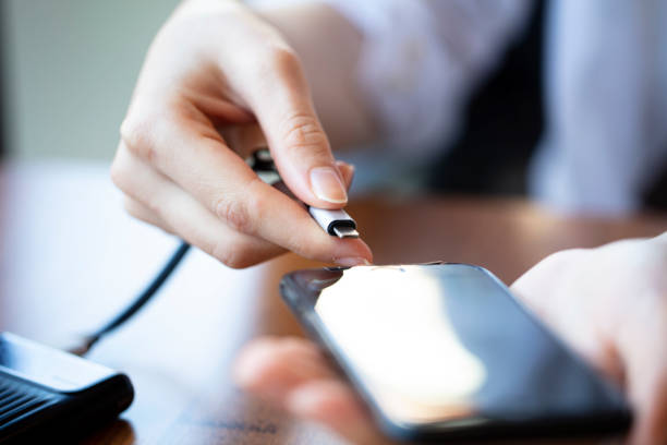 Woman hands connected to smart phone at home Phone tool, Charging, Smartphone, Battery phone charger stock pictures, royalty-free photos & images