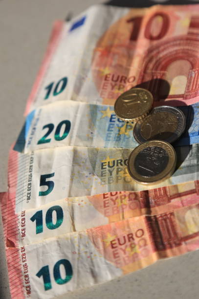istock Euro bills and coins 1204463560