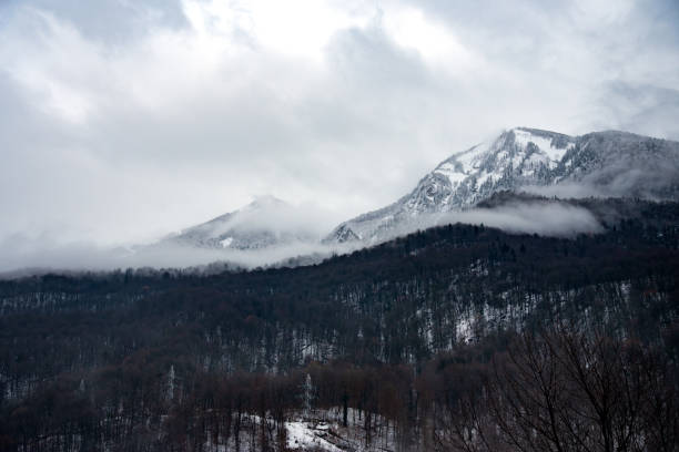 Winter mountain ski resort Rosa Khutor in Sochi.  Winter sunny day with cloudy in the Caucasus mountains.\