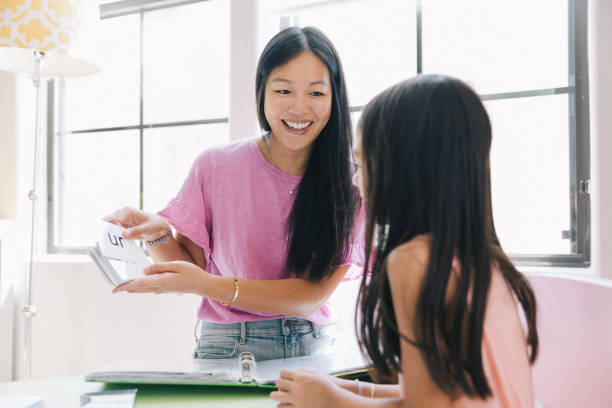 istock Mother is helping daughter with homework. 1204464826