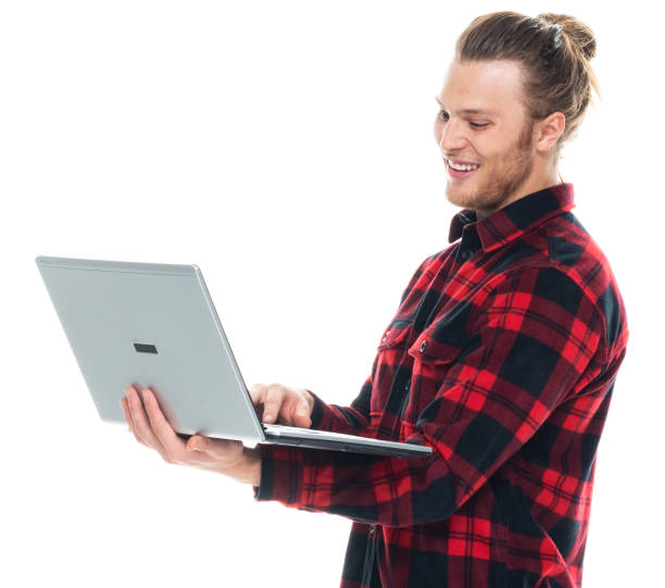 istock Caucasian young male standing wearing shirt and using computer 1204464929