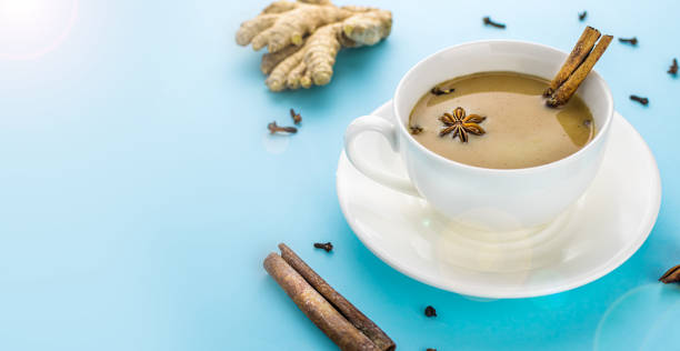 istock Traditional indian masala chai tea in white cup with spiced. With copy space. 1204465467