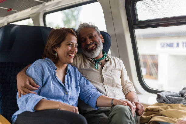 istock Embraced Inidan couple enjoying train ride 1204467409