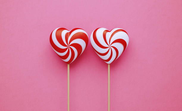 istock Valentine's Day Concept- Heart Shaped Lollipops on Pink Background 1204468165