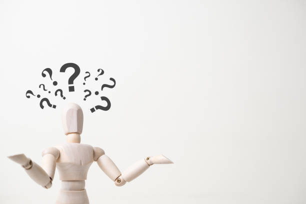 wooden mannequin with doubtful gesture on white background - confusion and asking question concept stock photo