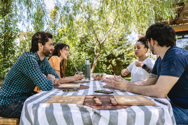 istock Latin couples having interesting talk at outdoor lunch 1204468711