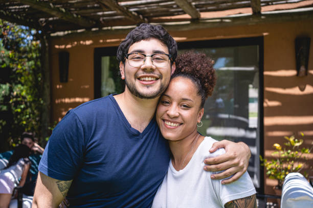 istock Happy Hispanic boyfriend hugging his girlfriend 1204468727