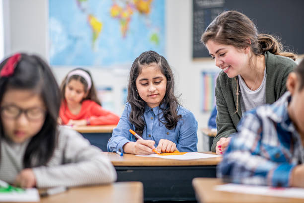 istock Teacher Helping a Student stock photo 1204471179