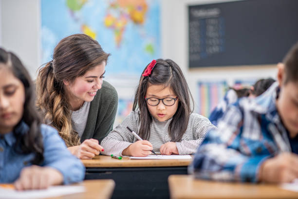 istock Teacher Helping a Student stock photo 1204471362