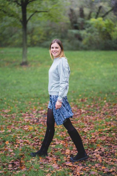 istock Happy Girl In Autumn Park 1204474675