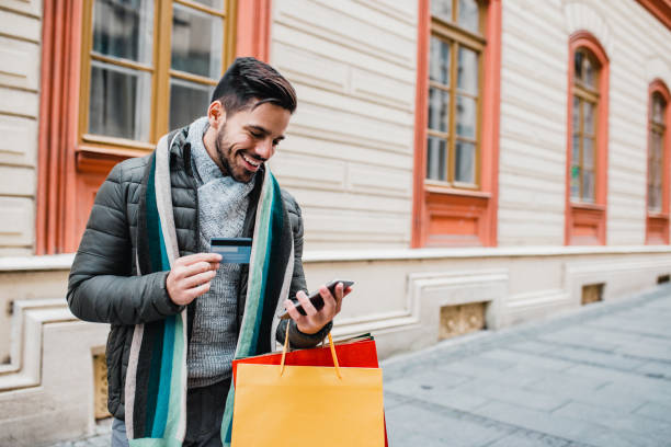 istock Young man in shopping with credit card 1204478165