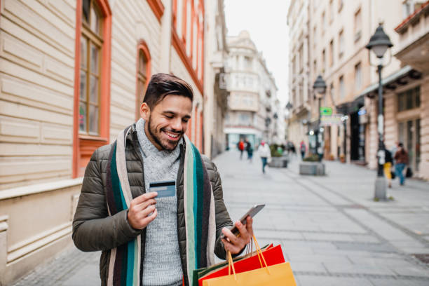 istock Young man in shopping with credit card 1204478200