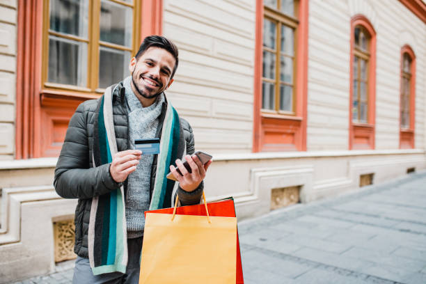 istock Young man in shopping with credit card 1204478354
