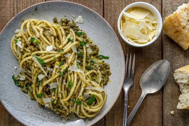 istock Italian bucatini pasta with pesto sauce. 1204478551