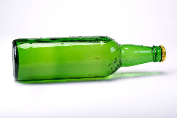 istock A glass bottle is lying at the white background, lemonade, alcohol. 1204478752