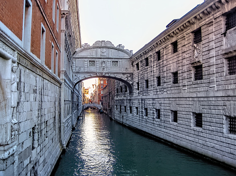 The Bridge of Sighs, Ponte dei Sospiri, in the evening sun with reflecting water, Venice, Italy