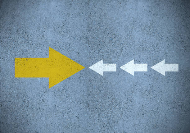 istock Strong yellow (idea) arrow against smaller old white (methods) 1204480337