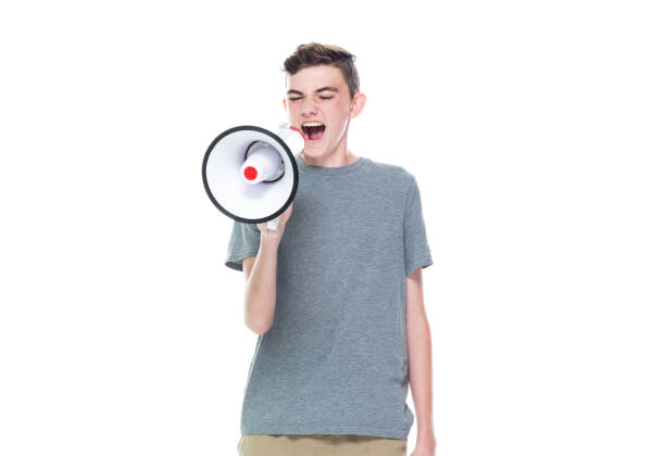 istock Caucasian boys standing and holding megaphone 1204481353