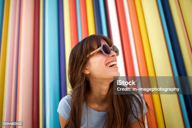 Närbild Glad Ung Kvinna Skrattar Med Solglasögon Mot Färgstark Bakgrund-foton och fler bilder på Människor