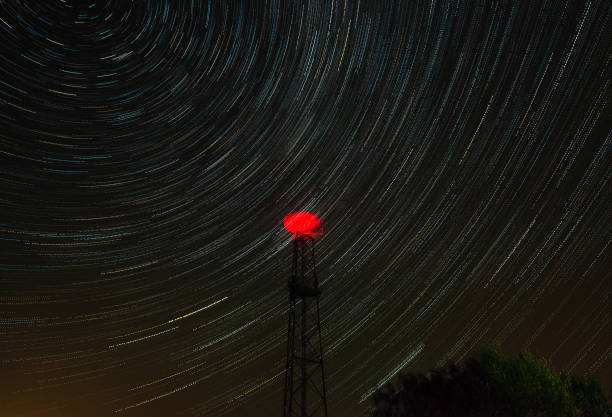 istock Star light trails and telecommunications tower in the night 1204483529