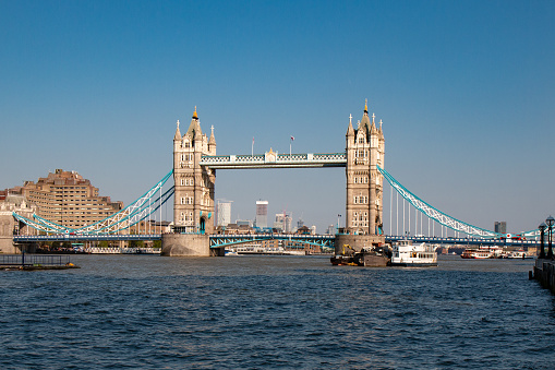 Tower Bridge is a combined bascule and suspension bridge in London, built between 1886 and 1894. The bridge crosses the River Thames close to the Tower of London and has become an iconic symbol of London.