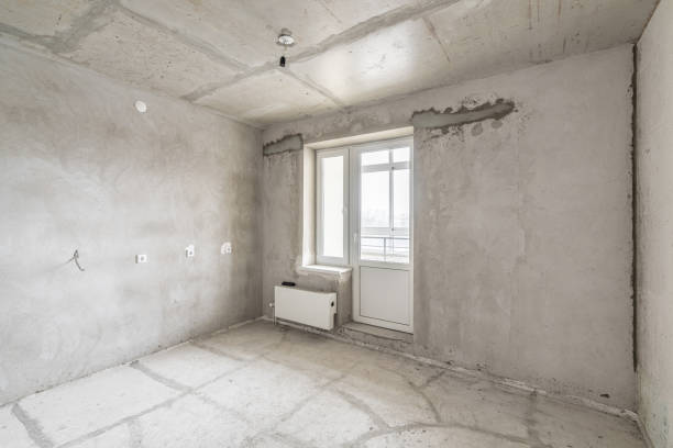 istock Empty interior for design, gray concrete wall. Empty room. Space for text and picture. Concrete walls, slabs, interior of a new residential building. Partitions in a new apartment. 1204489189