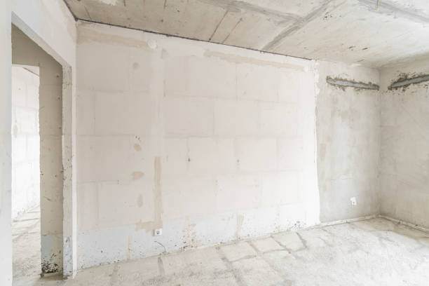 istock Empty interior for design, gray concrete wall. Empty room. Space for text and picture. Concrete walls, slabs, interior of a new residential building. Partitions in a new apartment. 1204490383