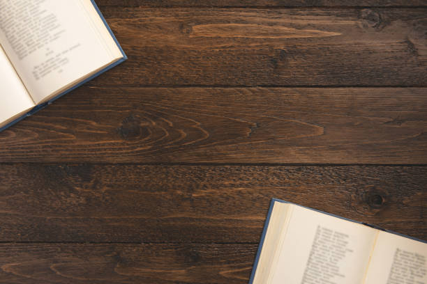 istock Open books  isolated on wooden background. Flat lay, top view, copy space. 1204490799