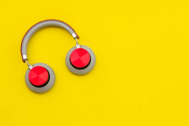 istock Red headphones on yellow background. Music concept. 1204490833