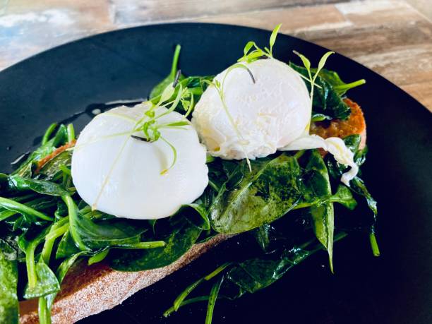 Poached Eggs with Sauted Baby Spinach on Sourdough Toast Breakfast
