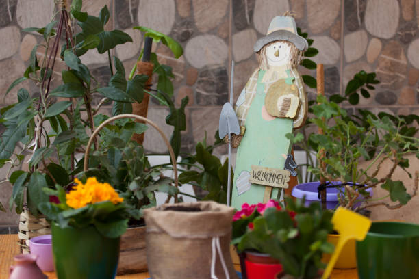istock scarecrow in flowers 1204492927
