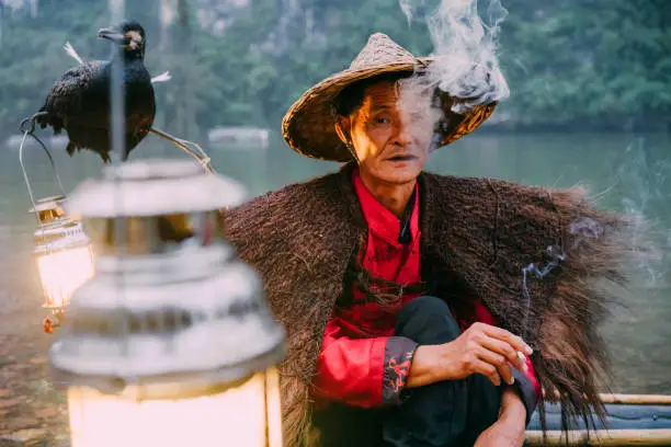 Photo of Chinese Fisherman smoking, Li River, China