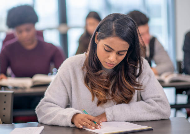 istock Female Indian University Student Writing stock photo 1204496813