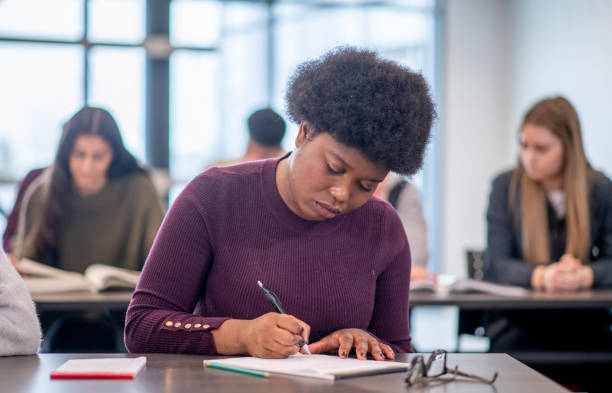 istock Female African University Student Writing stock photo 1204496822