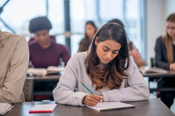istock Female Indian University Student Writing stock photo 1204496830