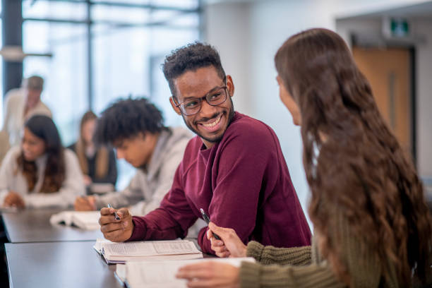istock University Students Sharing a Textbook in Class stock photo 1204496835